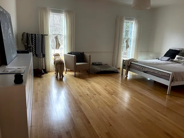 a bedroom with furniture and a window