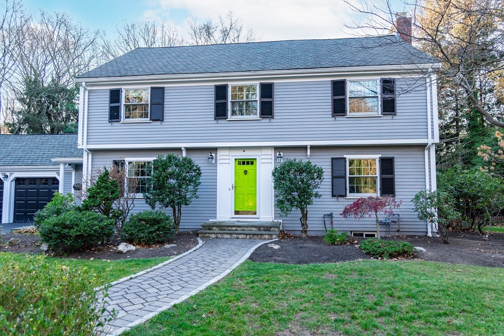 a front view of house and yard with green space