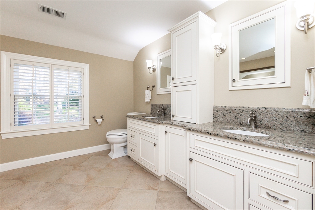 66 Suffolk Road Wellesley, MA 02481 - Photo 13 of 29 a spacious bathroom with a granite countertop toilet a sink and a mirror