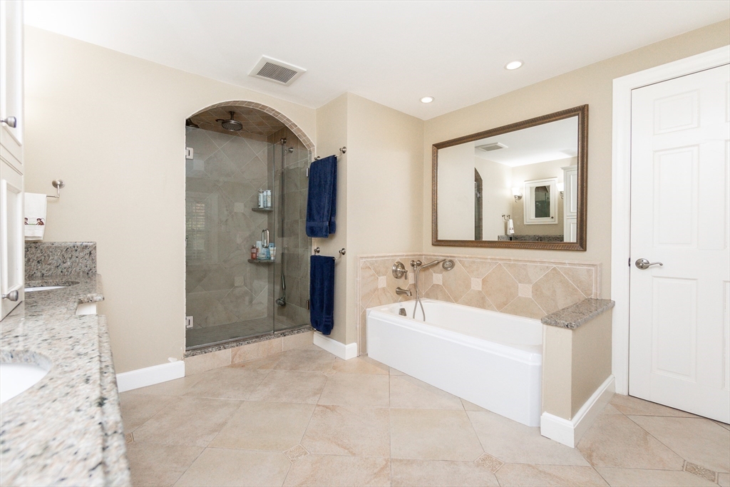 66 Suffolk Road Wellesley, MA 02481 - Photo 14 of 29 a bathroom with a tub a sink and mirror