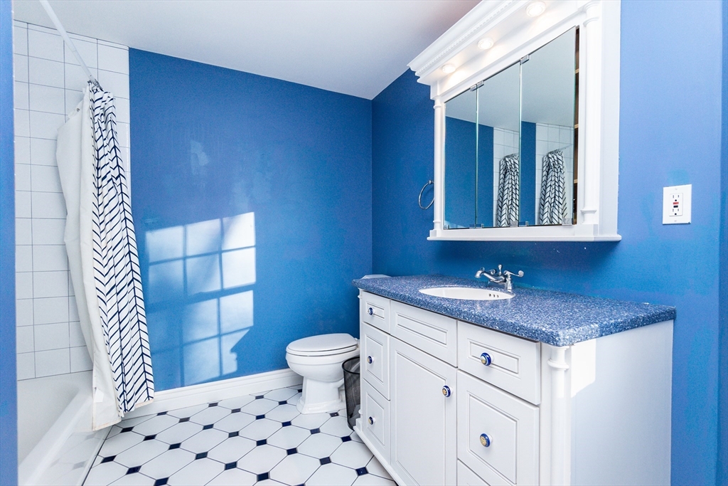 66 Suffolk Road Wellesley, MA 02481 - Photo 16 of 29 a bathroom with a granite countertop sink toilet and mirror
