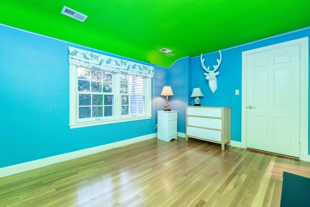 66 Suffolk Road Wellesley, MA 02481 - Photo 18 of 29 a view of an empty room with a window and wooden floor