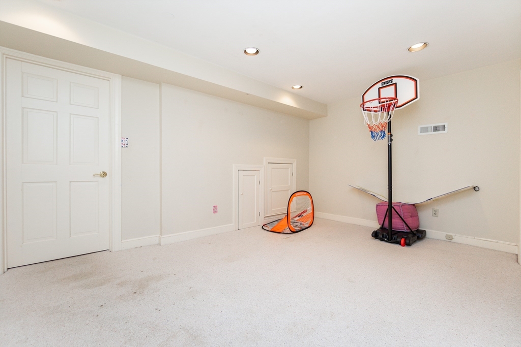 66 Suffolk Road Wellesley, MA 02481 - Photo 20 of 29 a view of a hallway with a chandelier