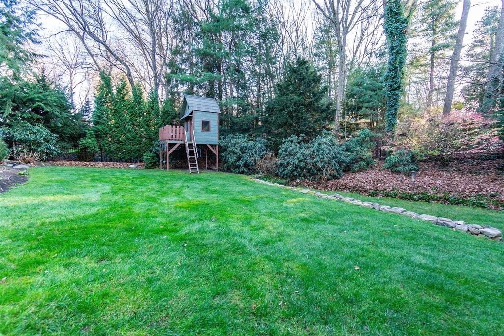 66 Suffolk Road Wellesley, MA 02481 - Photo 24 of 29 a view of a table and chairs in the garden in the back