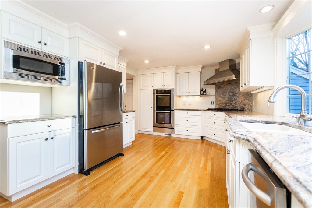 66 Suffolk Road Wellesley, MA 02481 - Photo 7 of 29 a kitchen with granite countertop a refrigerator a sink dishwasher and a stove with wooden floor
