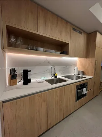 a kitchen with stainless steel appliances granite countertop a sink and a stove