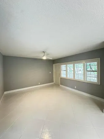 an empty room with a empty space and windows