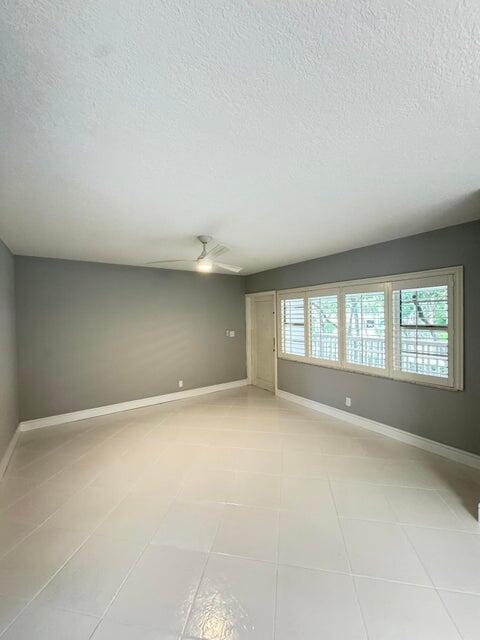 an empty room with a empty space and windows