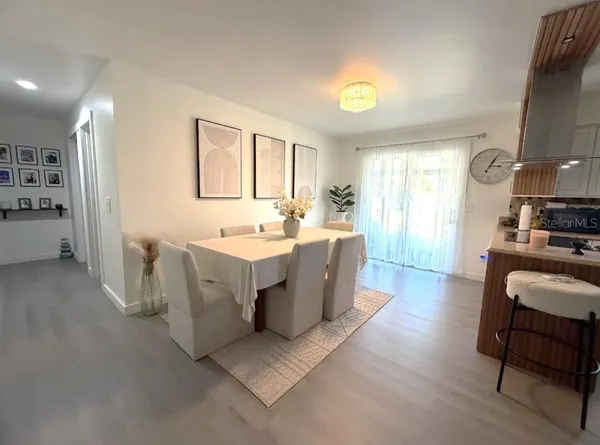 a large room with a couch and a view of dining room