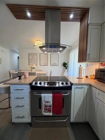 a kitchen with a stove and cabinets