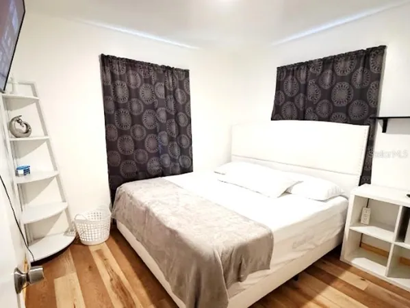 a bedroom with a bed and a couch