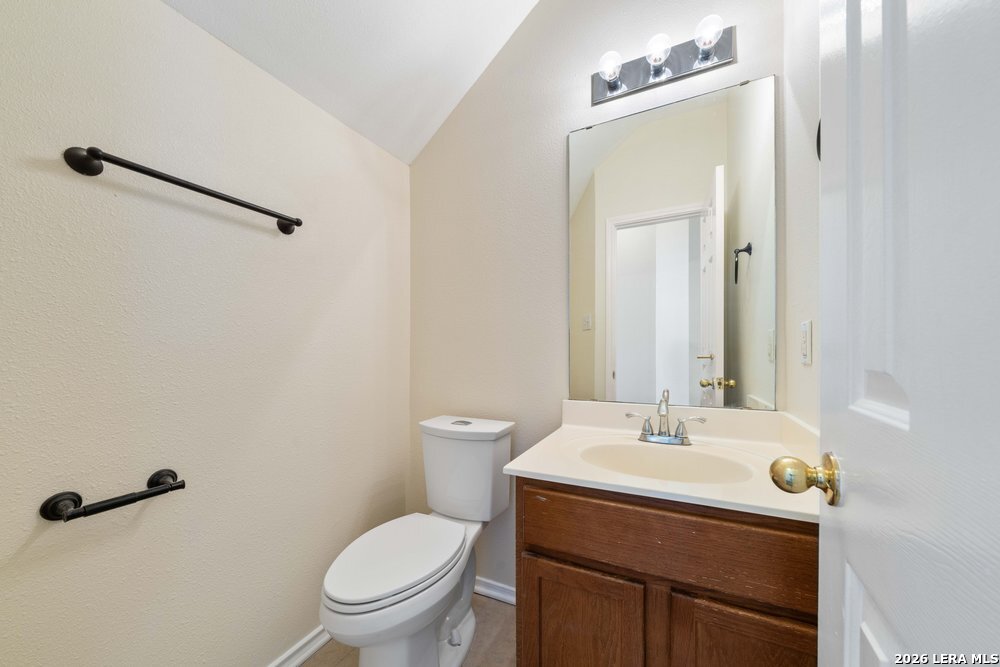 12319 Stable Rd Drive San Antonio, TX 78249 - Photo 18 of 34 a bathroom with a sink toilet and a mirror