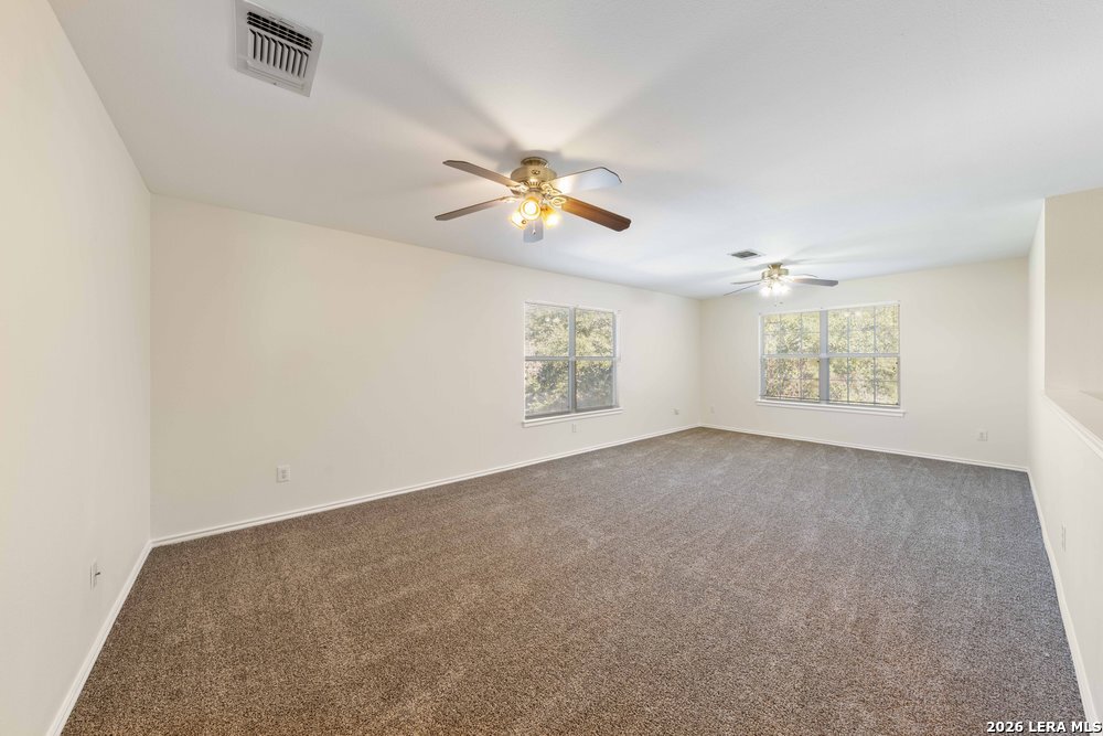 12319 Stable Rd Drive San Antonio, TX 78249 - Photo 20 of 34 an empty room with windows and fan