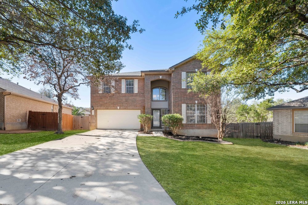 12319 Stable Rd Drive San Antonio, TX 78249 - Photo 2 of 34 a front view of a house with a garden and yard