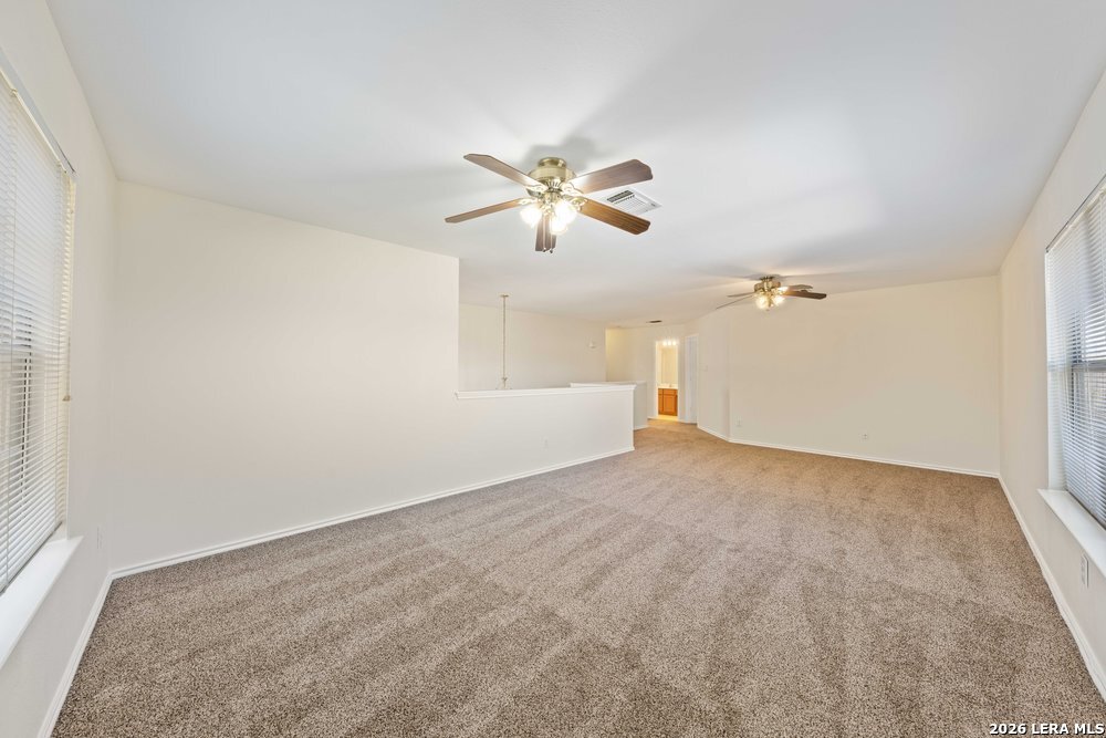 12319 Stable Rd Drive San Antonio, TX 78249 - Photo 21 of 34 a view of a room with a ceiling fan and a window