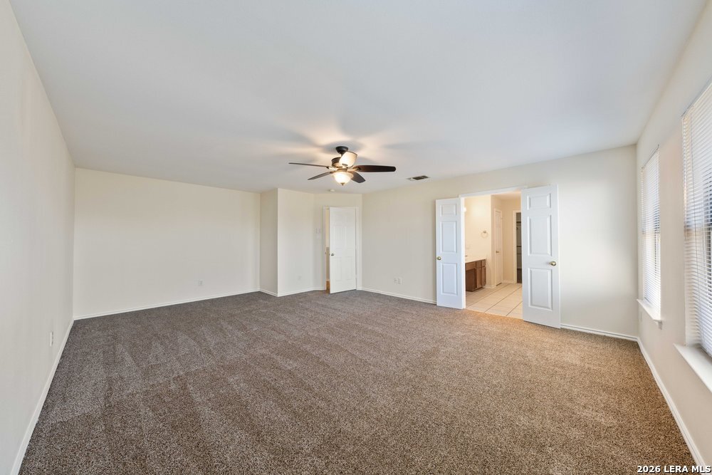 12319 Stable Rd Drive San Antonio, TX 78249 - Photo 22 of 34 a view of a big room with windows and chandelier fan