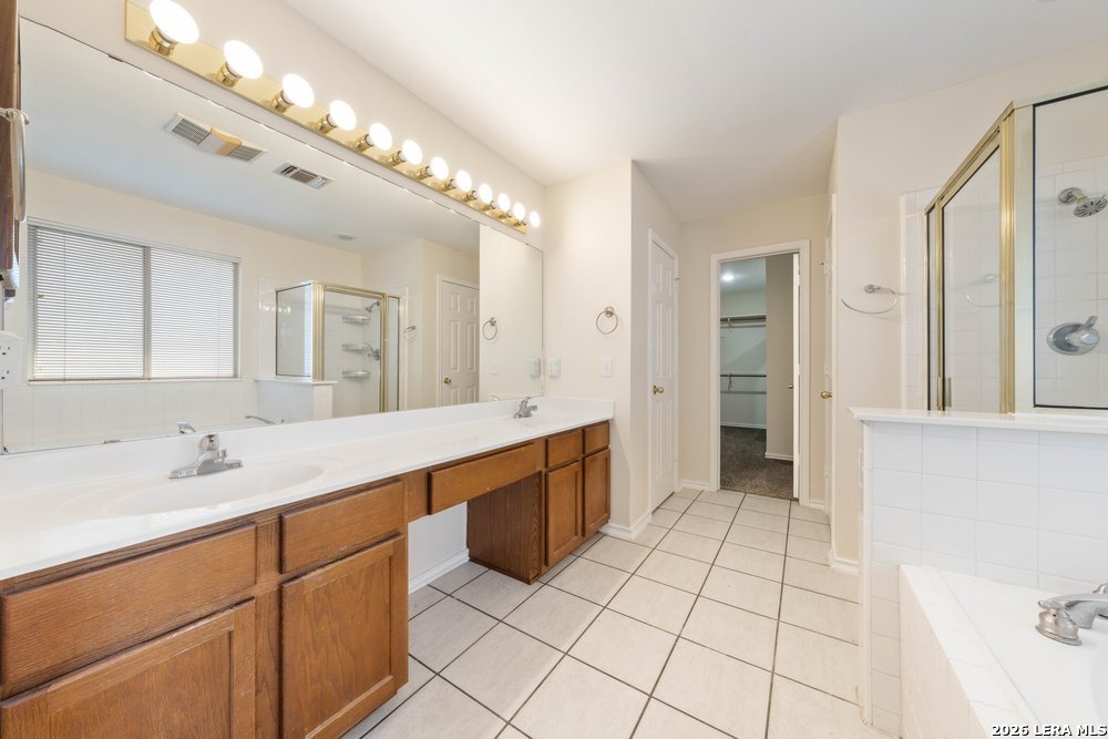 12319 Stable Rd Drive San Antonio, TX 78249 - Photo 24 of 34 a spacious bathroom with a granite countertop sink mirror and shower