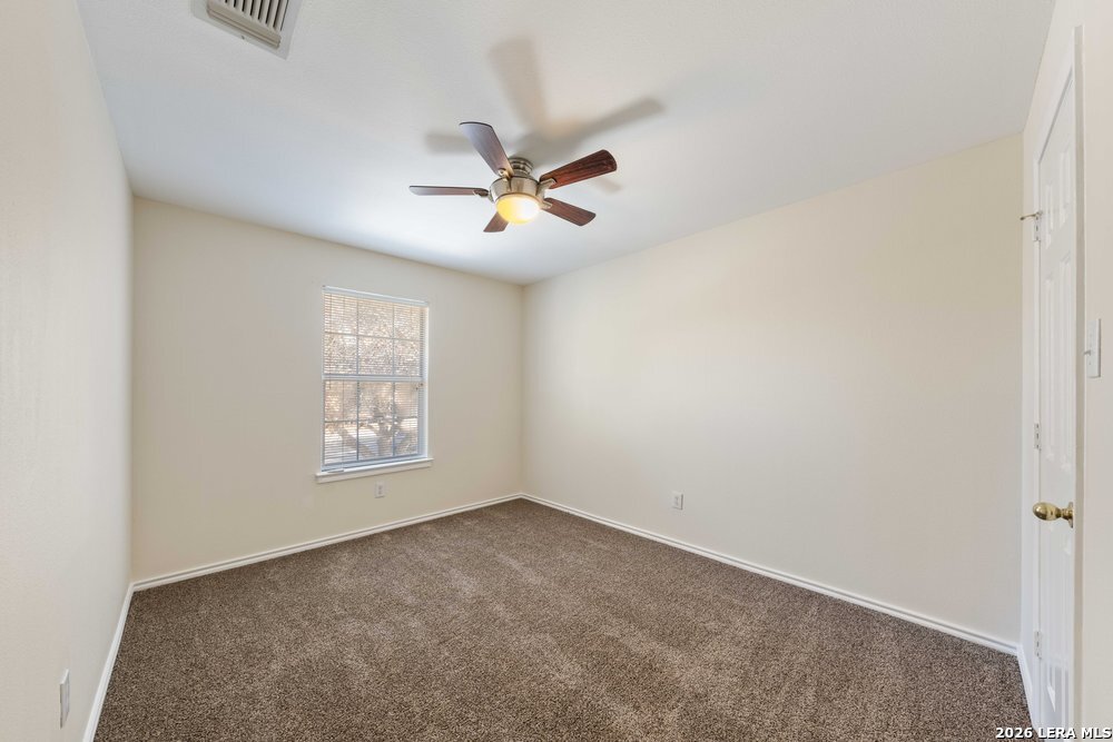 12319 Stable Rd Drive San Antonio, TX 78249 - Photo 29 of 34 a view of room with a ceiling fan and hardwood floor