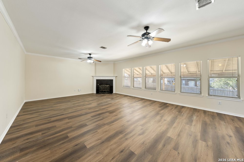 12319 Stable Rd Drive San Antonio, TX 78249 - Photo 8 of 34 wooden floor in an empty room with a window