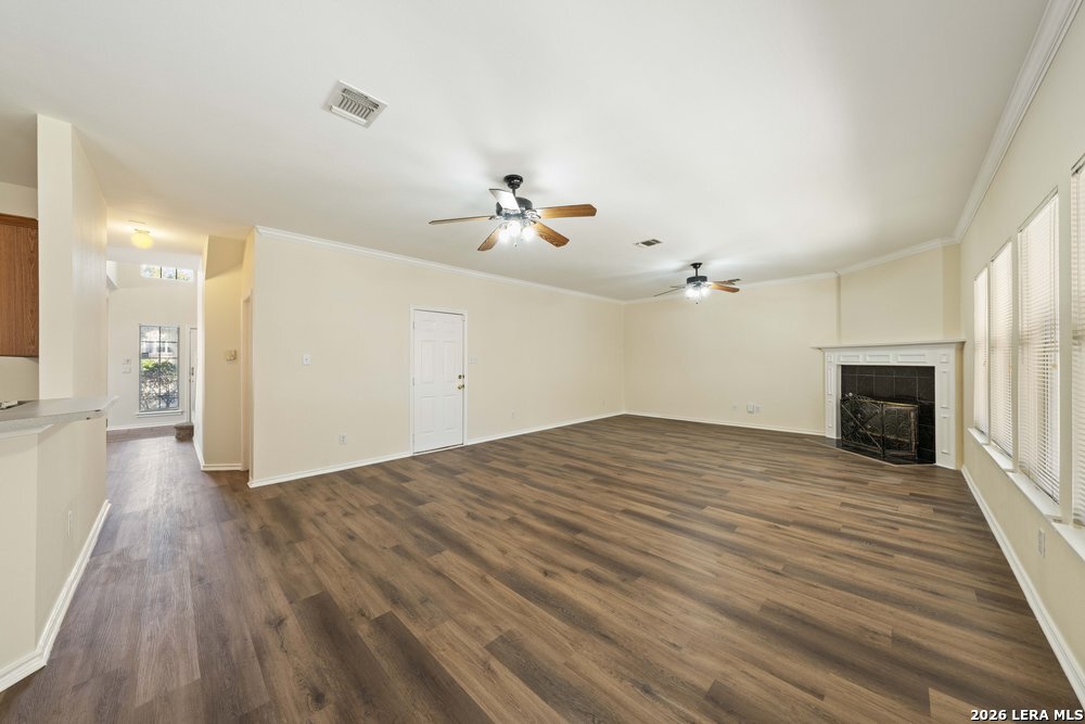 12319 Stable Rd Drive San Antonio, TX 78249 - Photo 9 of 34 wooden floor in an empty room with a fireplace