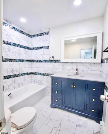 a bathroom with a sink a toilet and bathtub