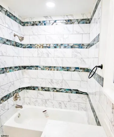 a bathroom with a bathtub and shower