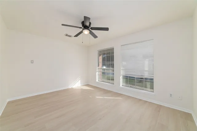 a view of wooden floor and windows in a room