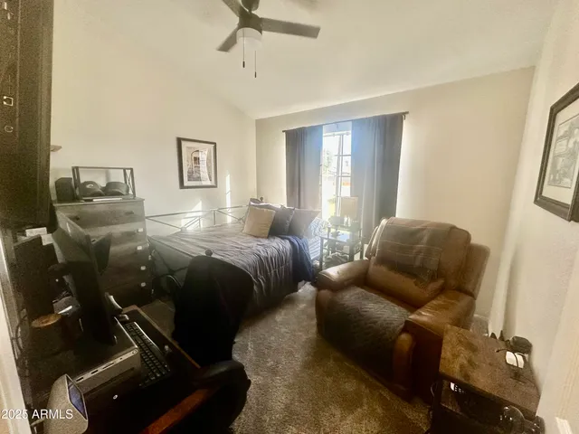 a bedroom with furniture and a window