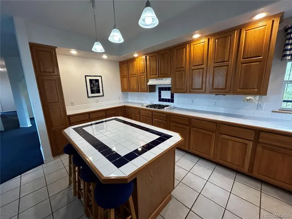 a kitchen with stainless steel appliances granite countertop a sink a stove and a refrigerator