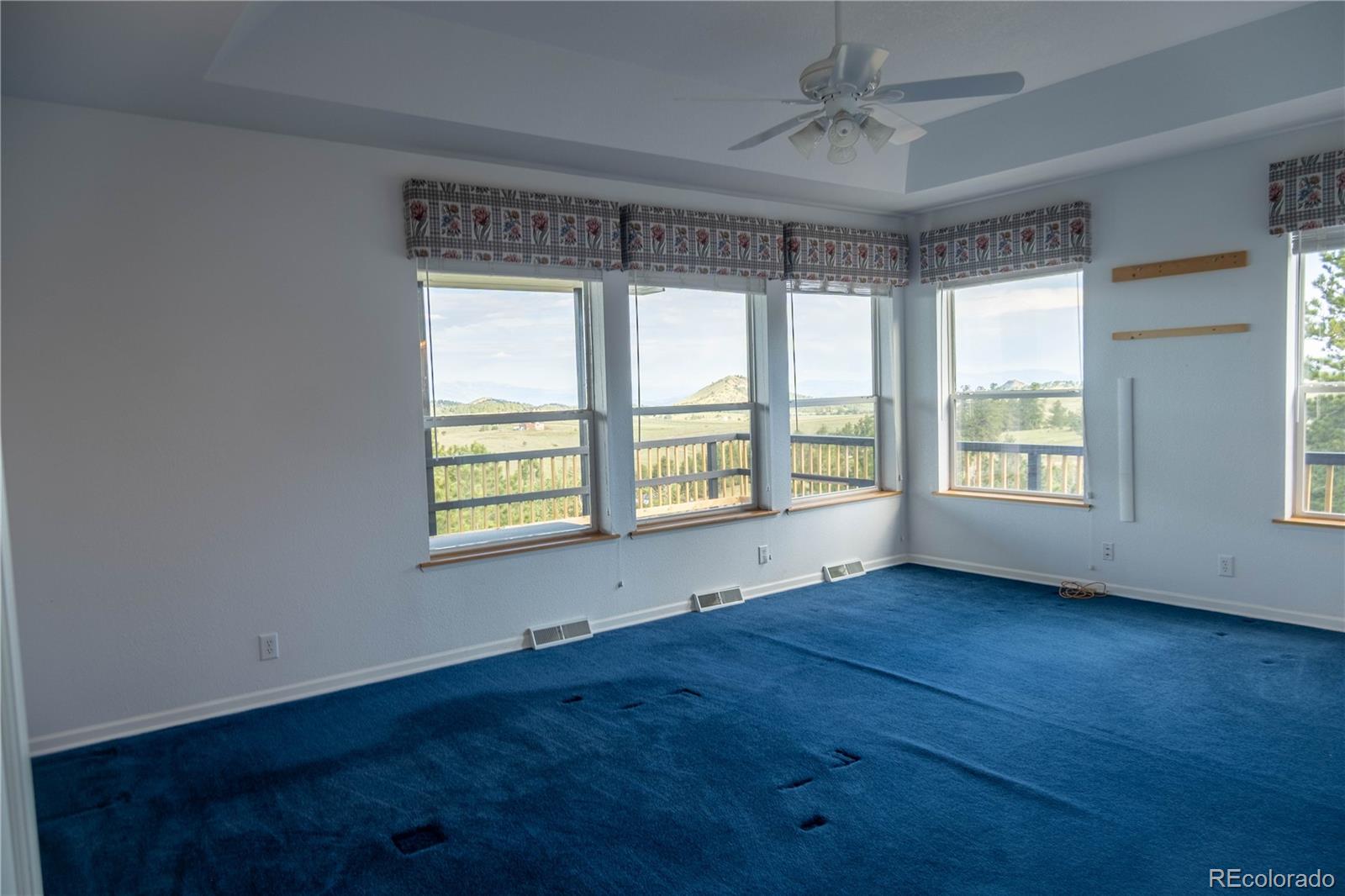 950 Junkins Loop Westcliffe, CO 81252 - Photo 17 of 35 a view of an empty room with wooden floor and a window