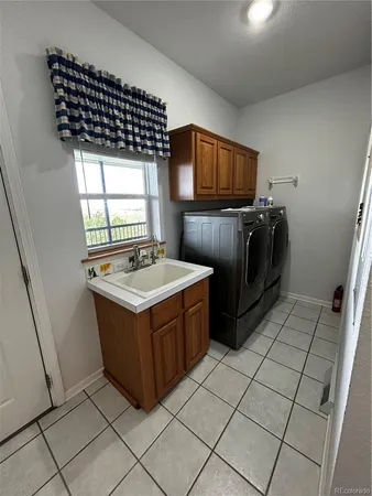 a kitchen with a stove sink and cabinets