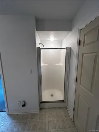 a bathroom with a glass shower door