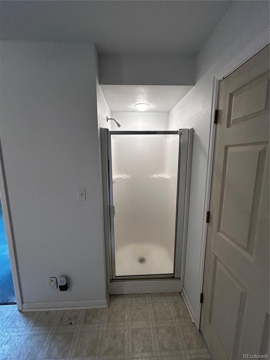 950 Junkins Loop Westcliffe, CO 81252 - Photo 28 of 35 a bathroom with a glass shower door