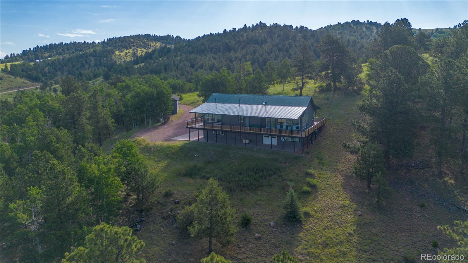 950 Junkins Loop Westcliffe, CO 81252 - Photo 34 of 35 a view of a house with a mountain and a forest