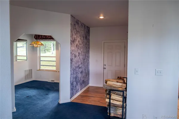 a view of room with window and wooden floor