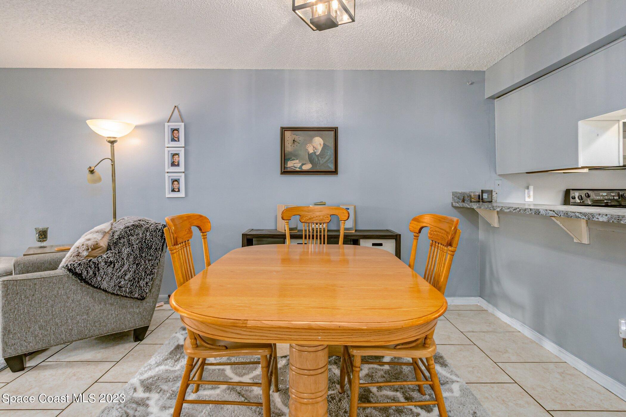 905 Prosperity Place, Unit 1902 Rockledge, FL 32955 - Photo 11 of 35 a dining room with furniture and wooden floor