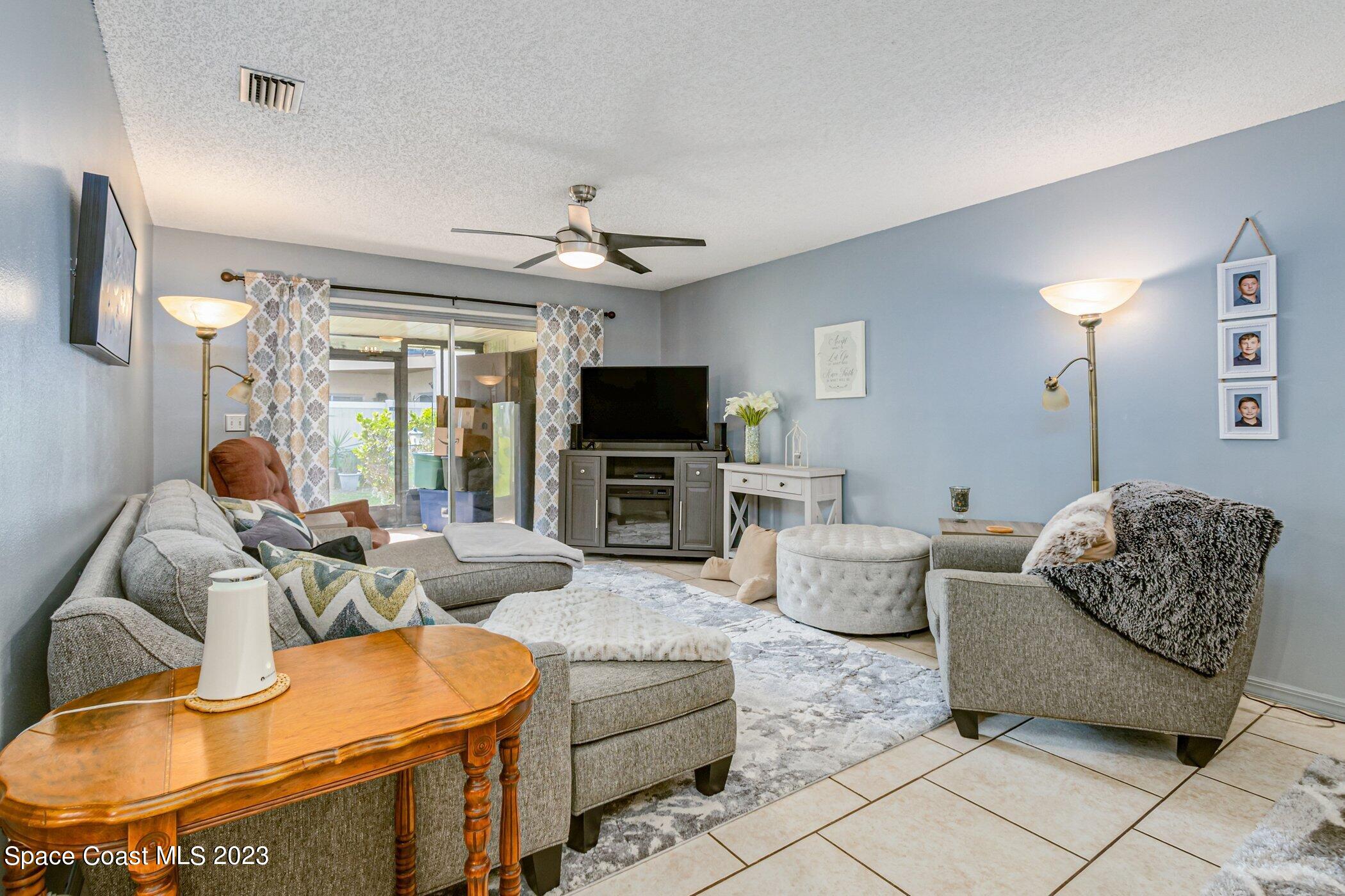 905 Prosperity Place, Unit 1902 Rockledge, FL 32955 - Photo 14 of 35 a living room with furniture and a flat screen tv