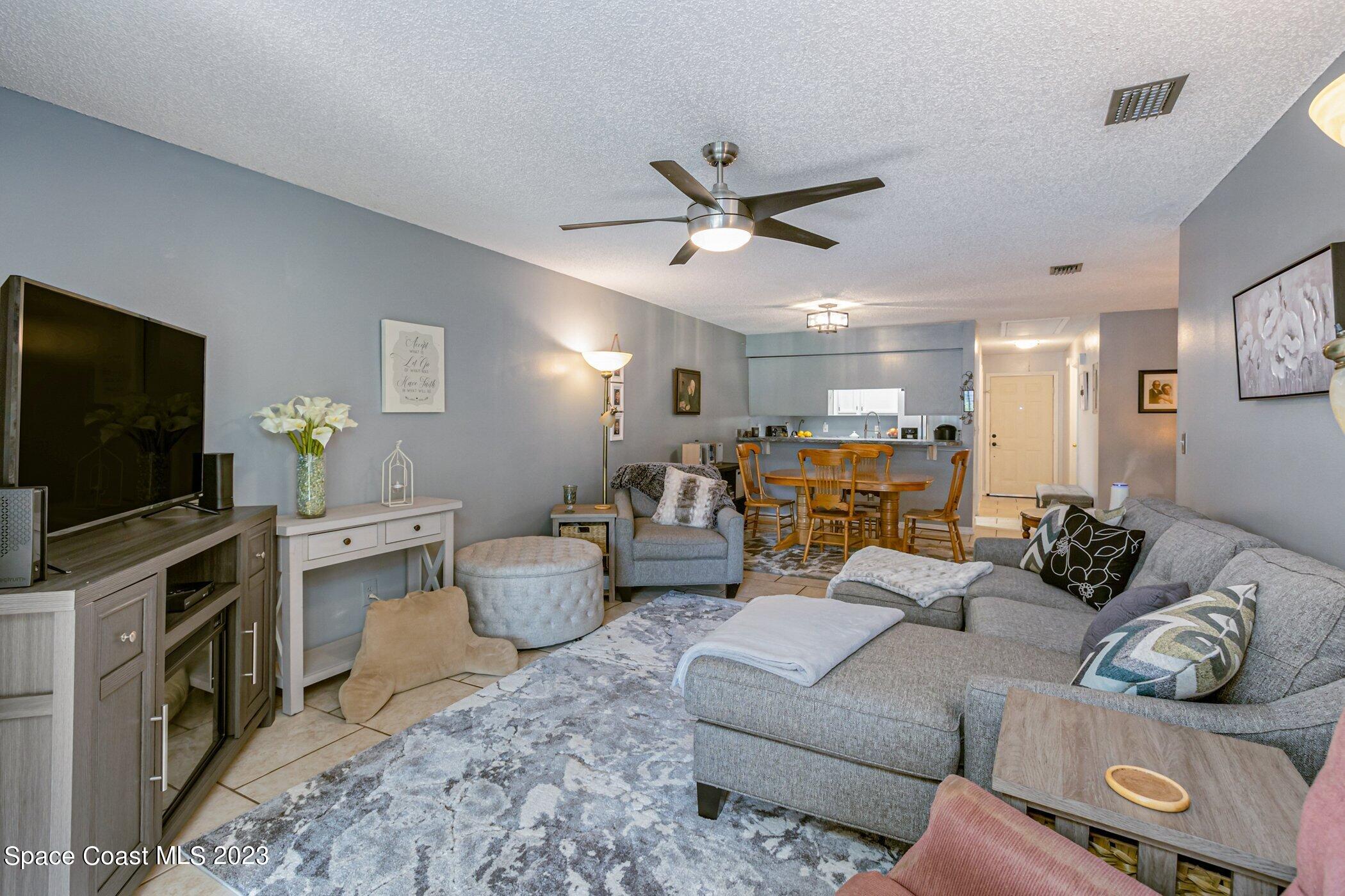 905 Prosperity Place, Unit 1902 Rockledge, FL 32955 - Photo 15 of 35 a living room with furniture and a flat screen tv