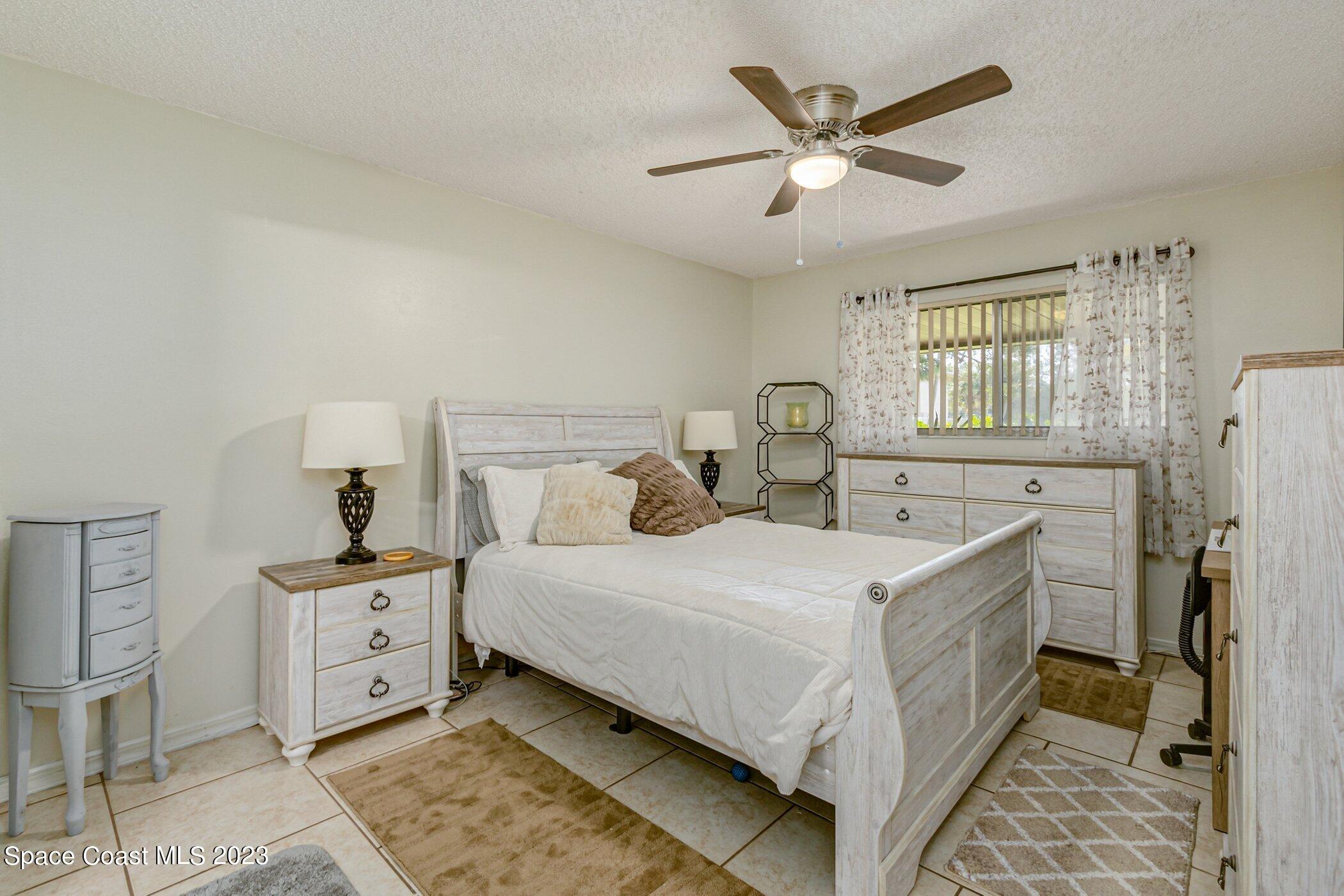 905 Prosperity Place, Unit 1902 Rockledge, FL 32955 - Photo 16 of 35 a bedroom with a bed and a window
