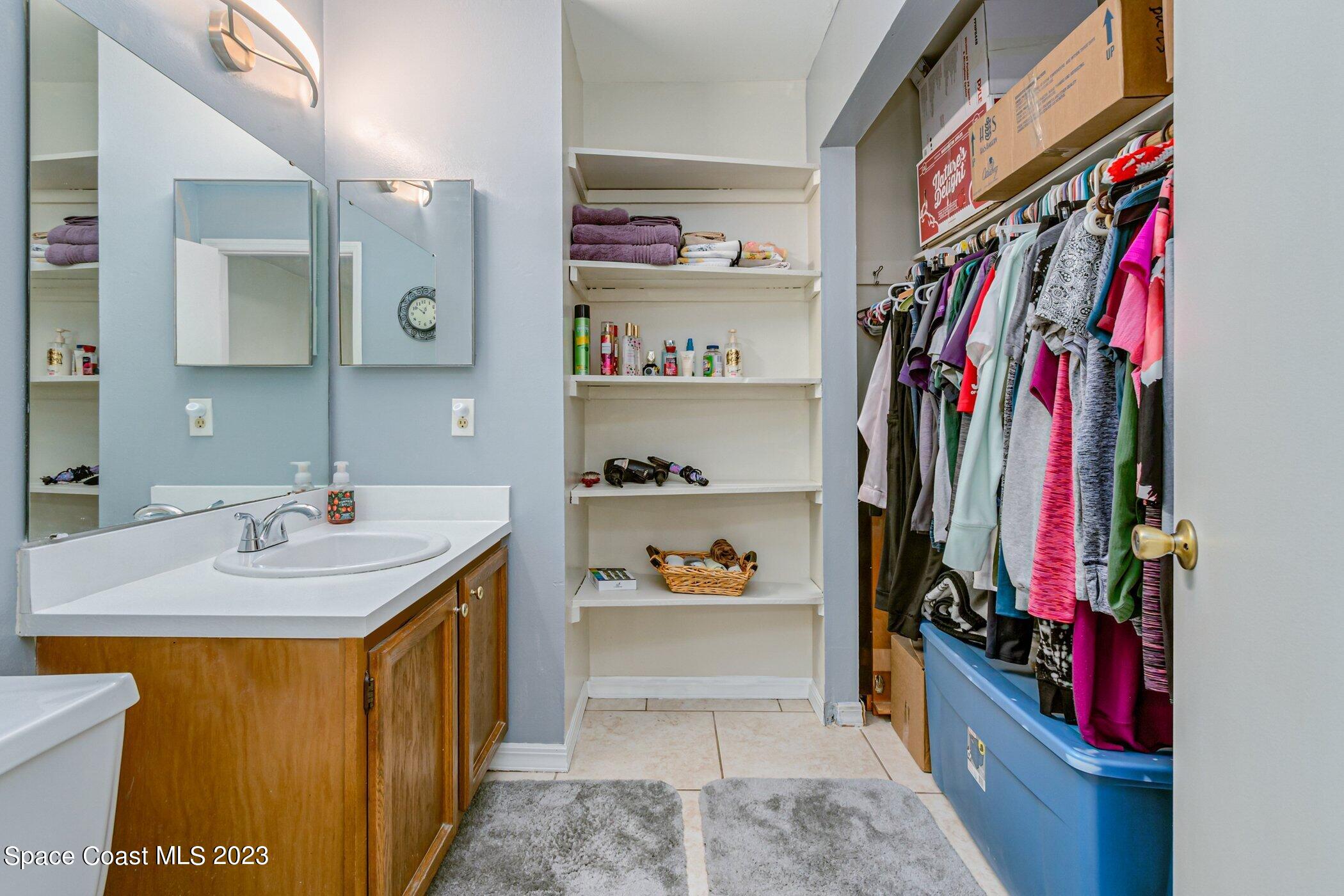 905 Prosperity Place, Unit 1902 Rockledge, FL 32955 - Photo 19 of 35 a view of walk in closet with clothes and shoes
