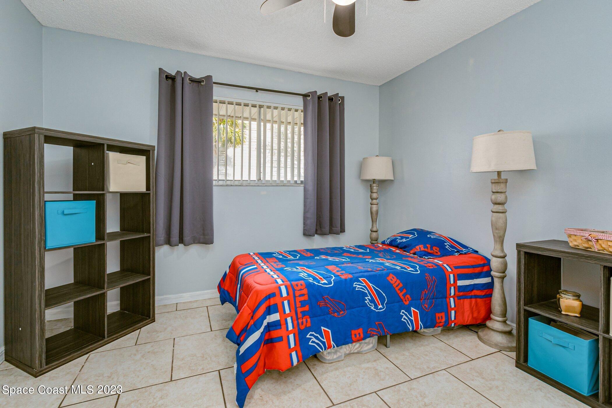 905 Prosperity Place, Unit 1902 Rockledge, FL 32955 - Photo 20 of 35 a bedroom with a bed and a television