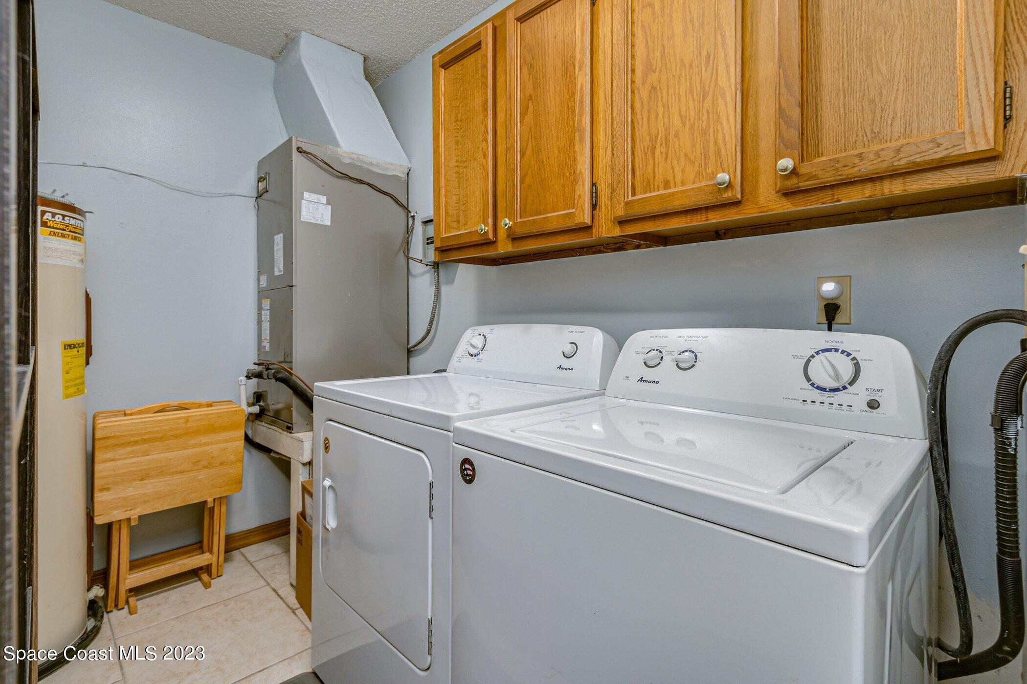 905 Prosperity Place, Unit 1902 Rockledge, FL 32955 - Photo 23 of 35 a utility room with dryer and washer