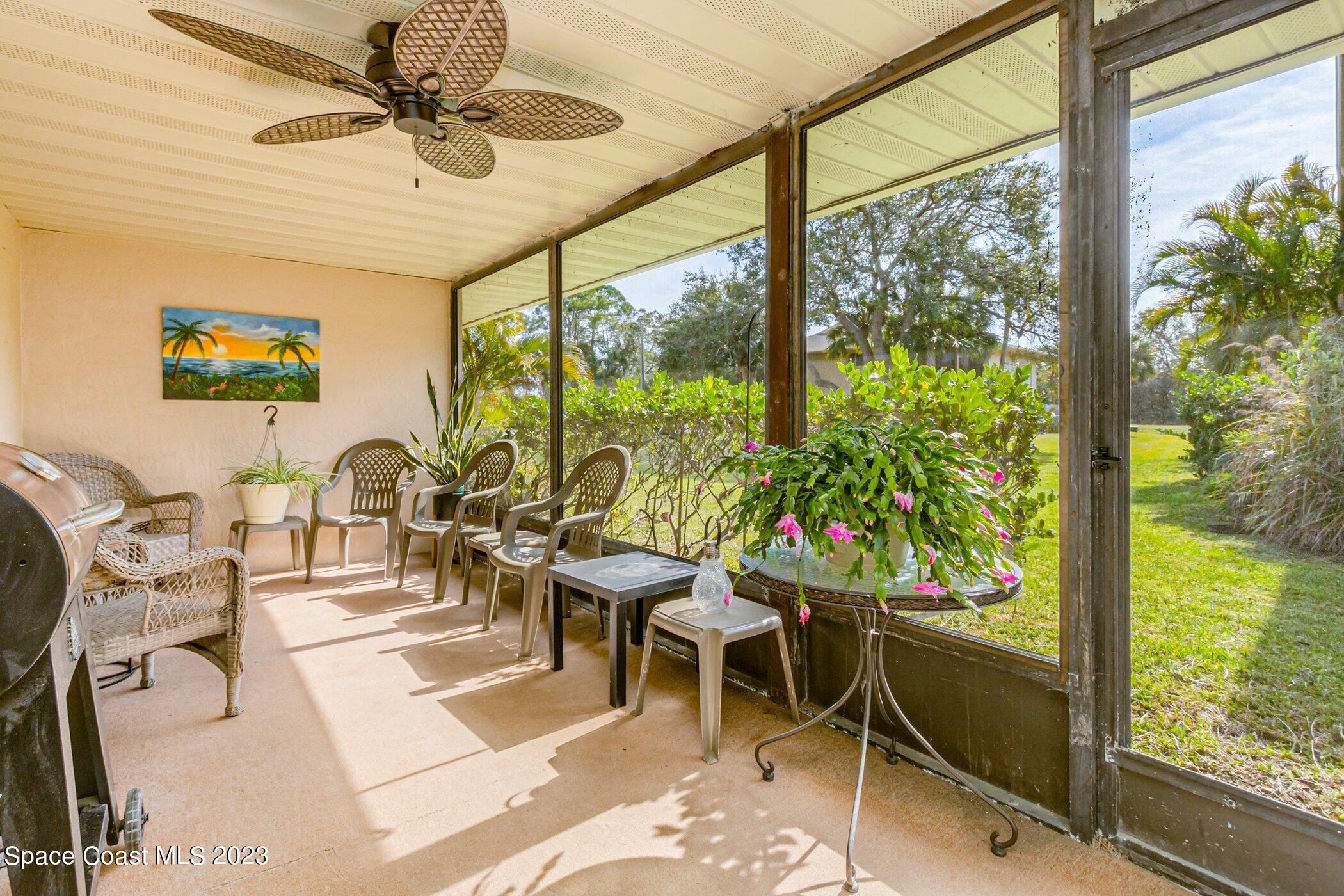 905 Prosperity Place, Unit 1902 Rockledge, FL 32955 - Photo 25 of 35 a room with lots of tables a large window and chairs