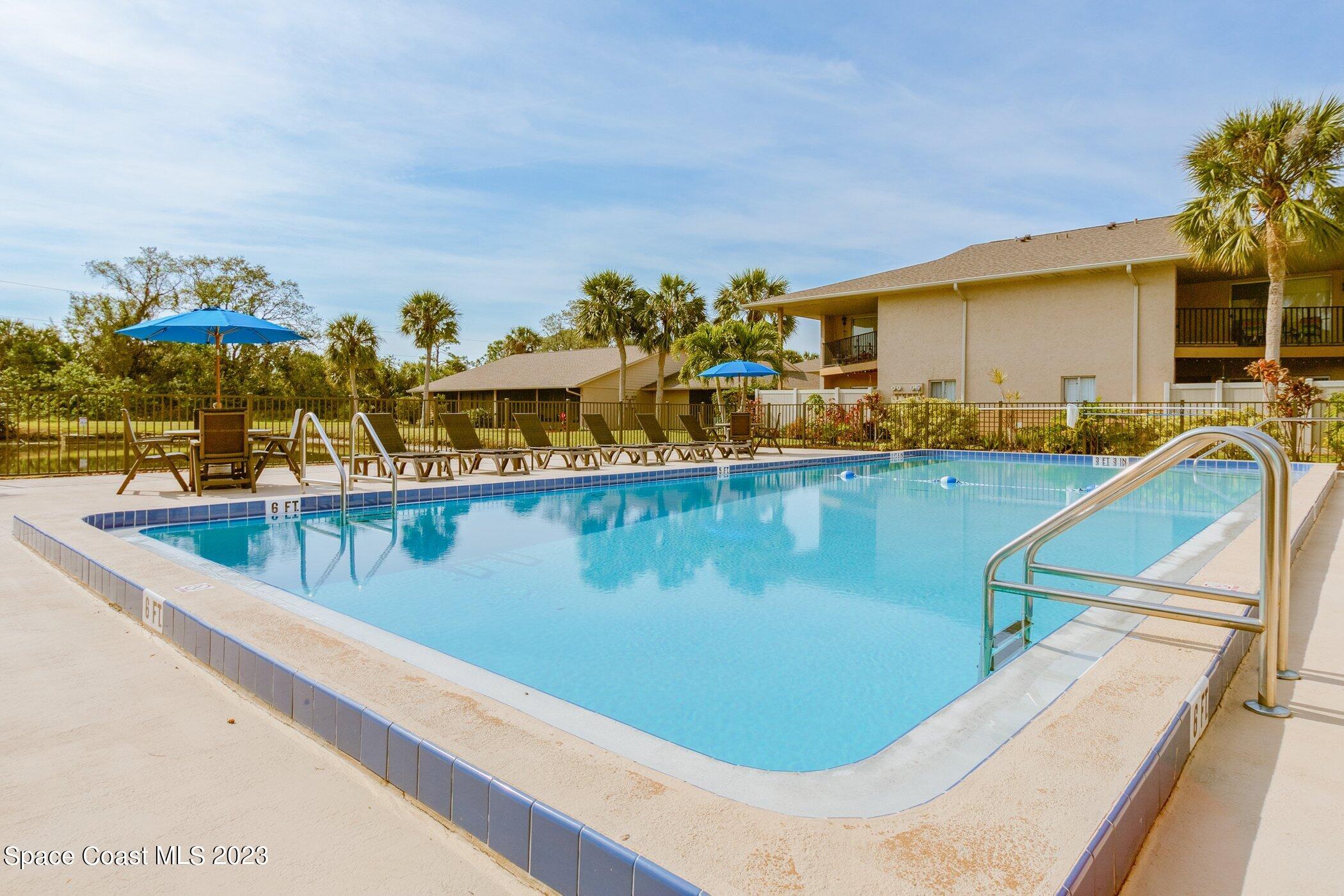 905 Prosperity Place, Unit 1902 Rockledge, FL 32955 - Photo 27 of 35 a view of a swimming pool with a lounge chair