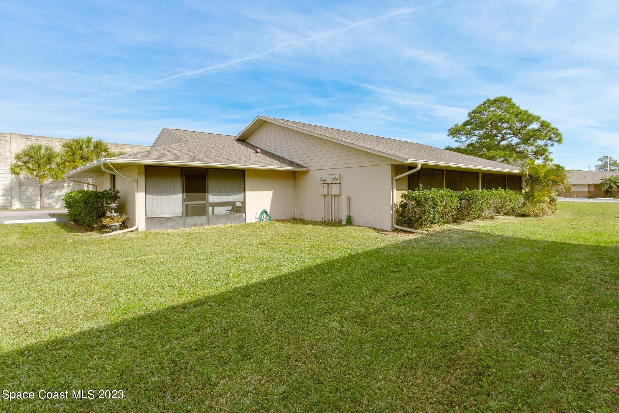 905 Prosperity Place, Unit 1902 Rockledge, FL 32955 - Photo 3 of 35 a front view of a house with garden