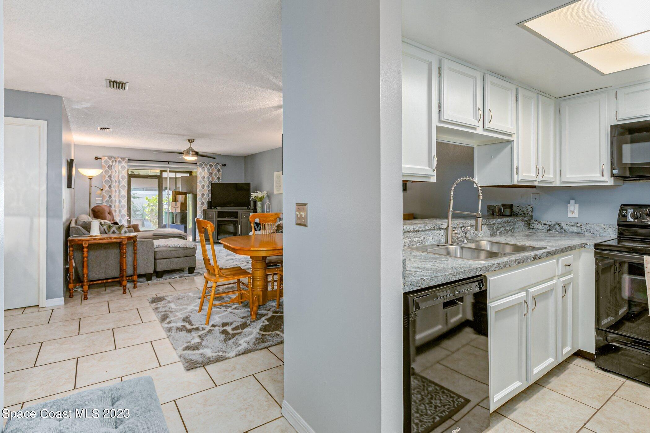 905 Prosperity Place, Unit 1902 Rockledge, FL 32955 - Photo 9 of 35 a kitchen with stainless steel appliances granite countertop a sink and cabinets