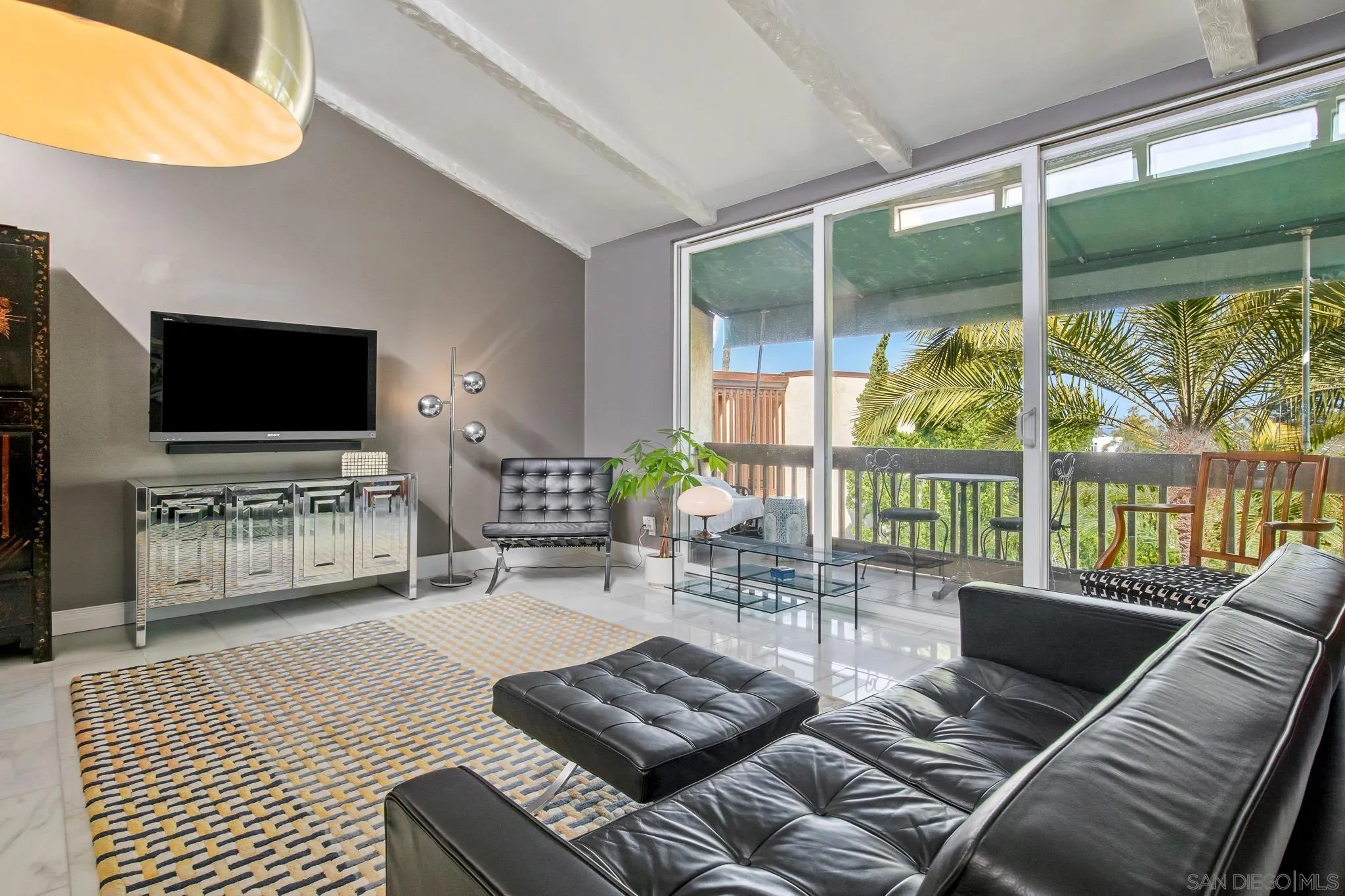 6455 La Jolla Boulevard, Unit 308 La Jolla, CA 92037 - Photo 14 of 18 a living room with furniture a flat screen tv and floor to ceiling window