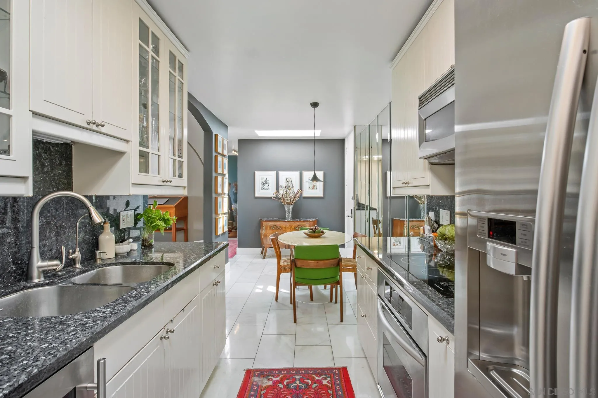 6455 La Jolla Boulevard, Unit 308 La Jolla, CA 92037 - Photo 4 of 18 a kitchen with stainless steel appliances granite countertop a sink a stove and a refrigerator