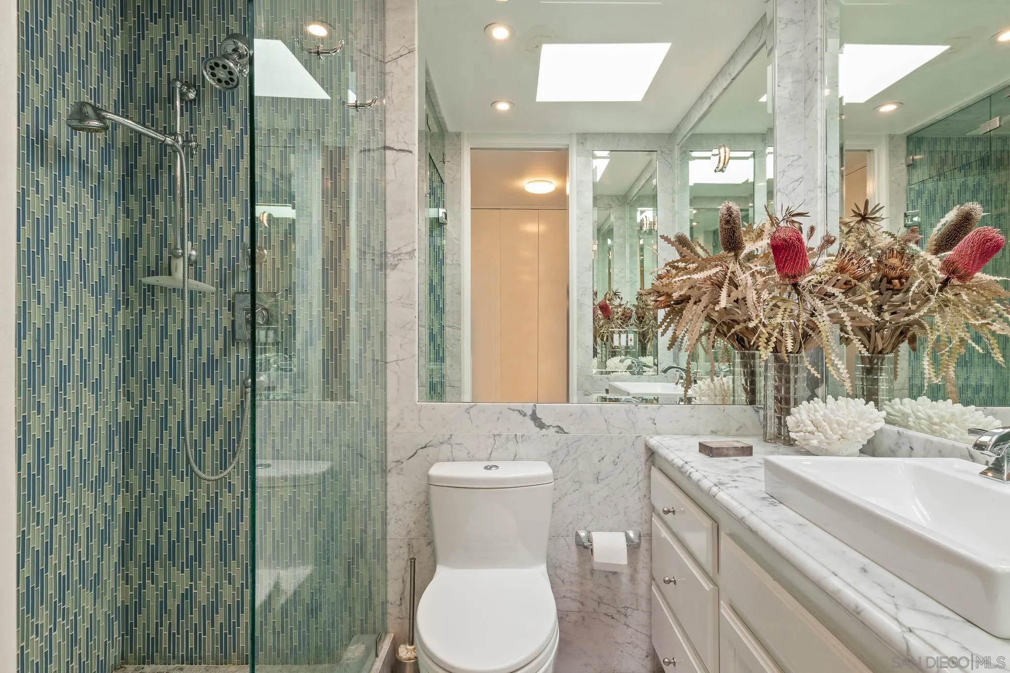 6455 La Jolla Boulevard, Unit 308 La Jolla, CA 92037 - Photo 8 of 18 a bathroom with a granite countertop sink a toilet and shower