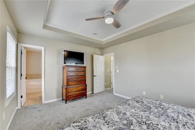 a bathroom with a granite countertop sink a large mirror and a bathtub